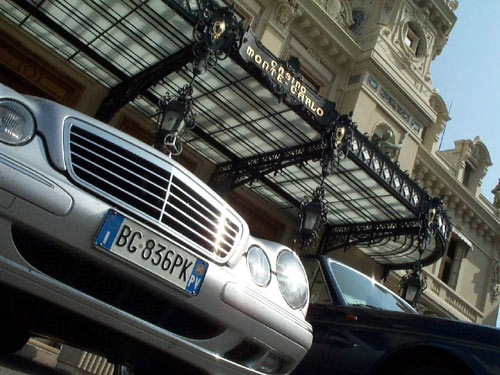 A Mercedes and Rolls Royce parked in front of the Casino entrance.  Monte Carlo, Principality of Monaco.