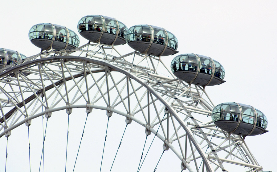 One of London's latest modern attractions, the London Eye, a giant big wheel ( ferris wheel ) which gives a birds eye view of the city from enclosed capsules.  London, U.K..